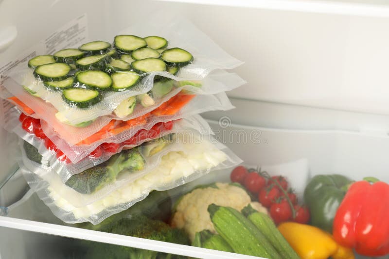 Vacuum Bags with Different Vegetables in Fridge, Space for Text. Food