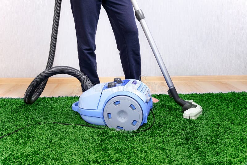 Vacuum Cleaner in Actionmen Cleaner a Carpet. Stock Image Image of