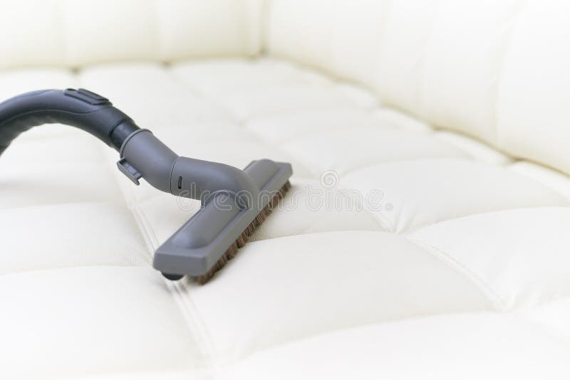 The Vacuum Cleaner Brush is on the Leather Sofa. Stock Photo Image of