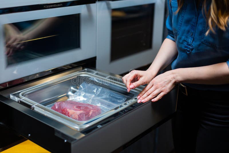 Vacuum Cleaner and Vacuum Packaging of Meat Products Stock Image