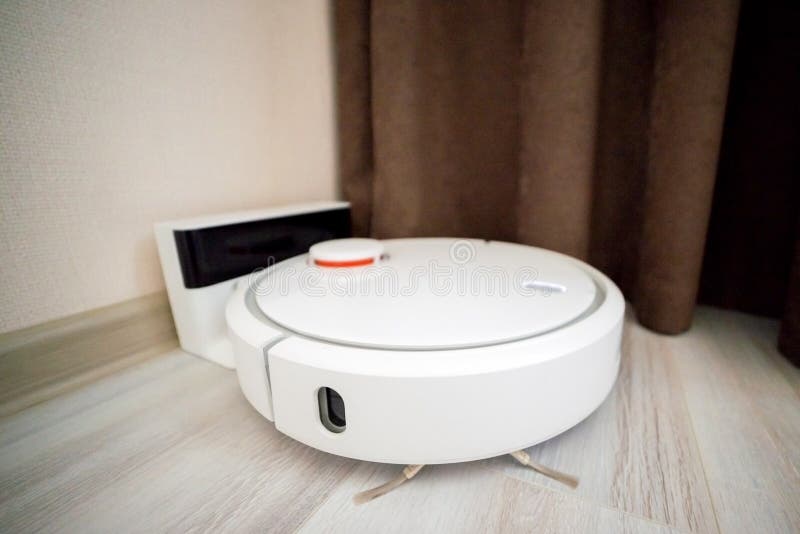 Robot Vacuum Cleaner Is Charging From The Dockstation Stock Photo