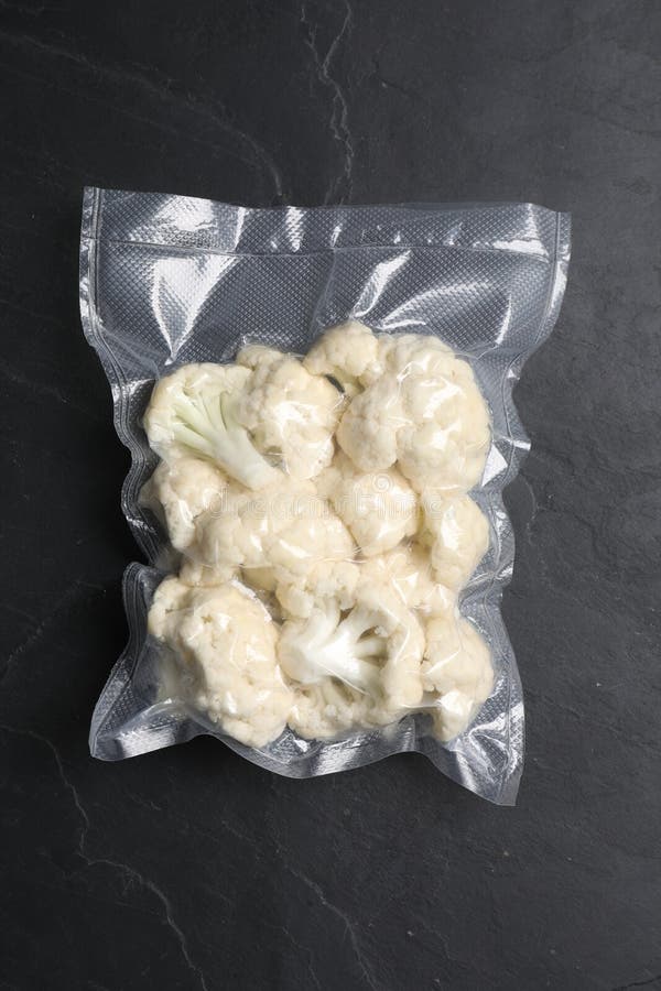 Vacuum Pack of Cauliflower on Dark Grey Table, Top View Stock Photo