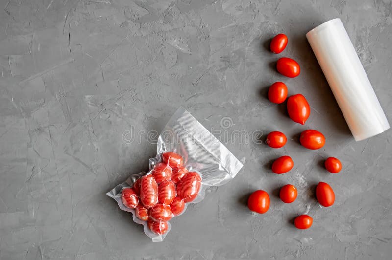 Vacuum Packaging of Fresh Tomatoes. Flat Lay. Copy Space Stock Photo
