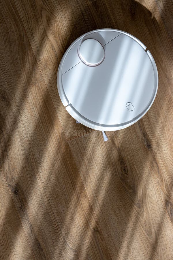 Vacuum Robot Cleaning at Home. Robot Vacuum Cleaner in the Modern Home
