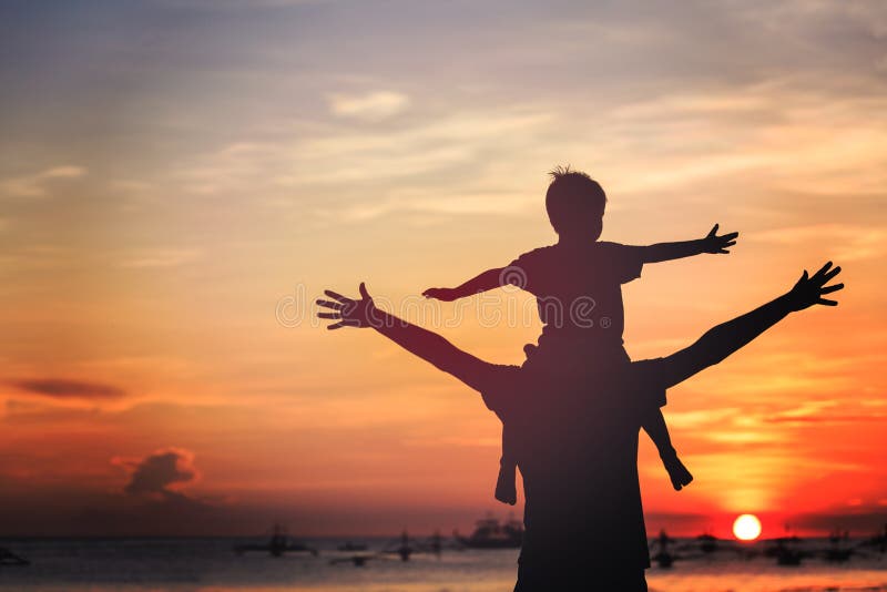 Father and son playing on sunset beach. Father and son playing on sunset beach