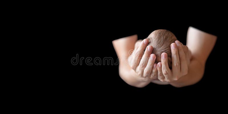 Father holding head of his newborn baby in hands on black background. Loving father hands holding cute sleeping newborn baby child. Close up picture with copy space. Father holding head of his newborn baby in hands on black background. Loving father hands holding cute sleeping newborn baby child. Close up picture with copy space