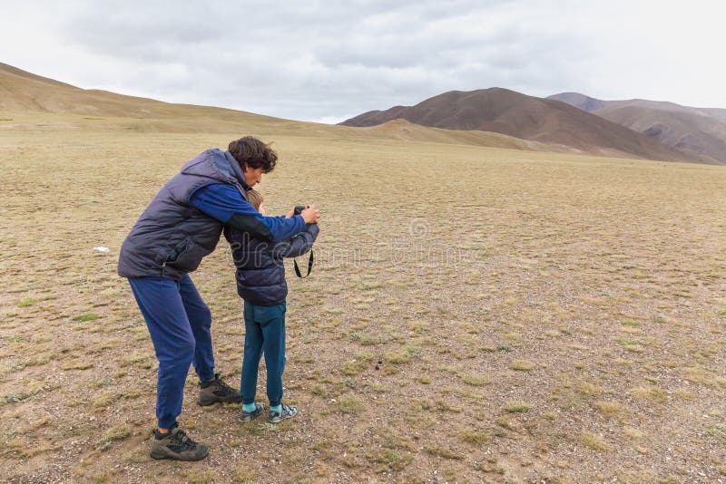 Father teaches son to take pictures in stepp of mongolian Altai. Father teaches son to take pictures in stepp of mongolian Altai.