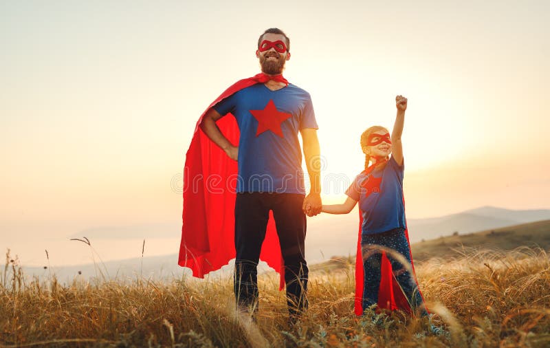 Concept of father`s day. dad and child daughter in hero superhero costume at sunset in nature. Concept of father`s day. dad and child daughter in hero superhero costume at sunset in nature