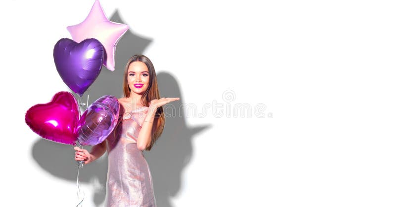 Valentine Beauty girl with pink heart shaped air balloons portrait pointing hand,  on white background