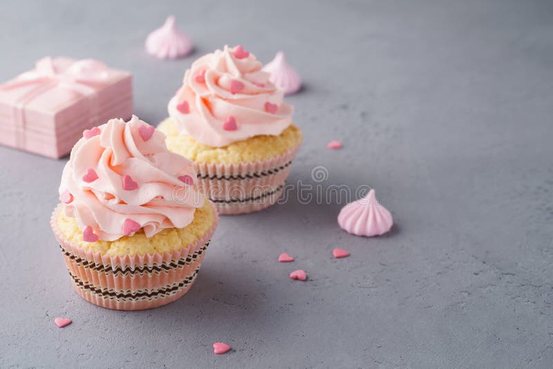 Valentine cupcakes decorated with sweet hearts and a gift box