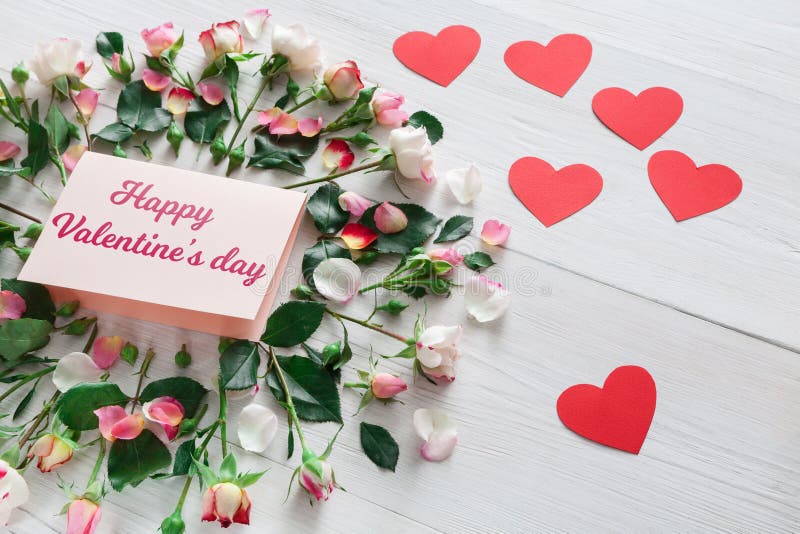 Valentine day background, hearts, card and flowers on white wood