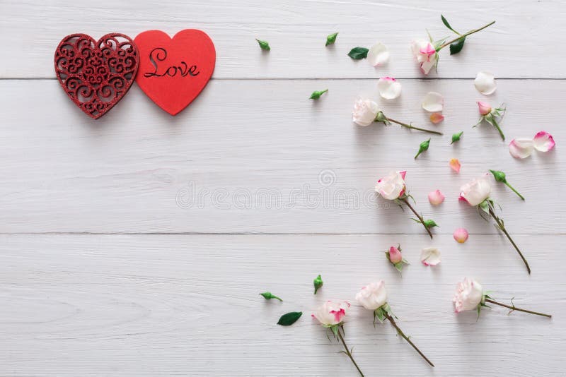 Valentine day background, hearts and flowers on white wood