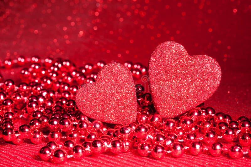 Two red hearts as Valentine day symbol with beards on the background