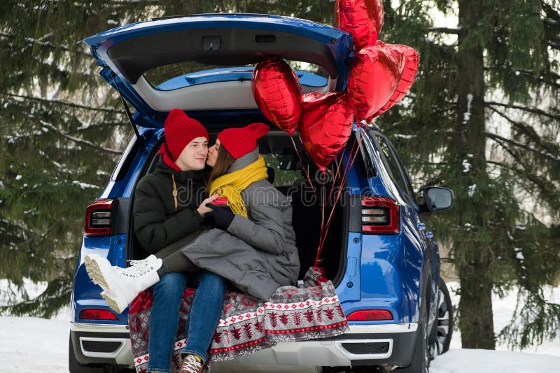 Valentine Gift. Happy Young Couple with Valentine&x27;s Day or birthday present. Happy Man giving a gift to his Girlfriend