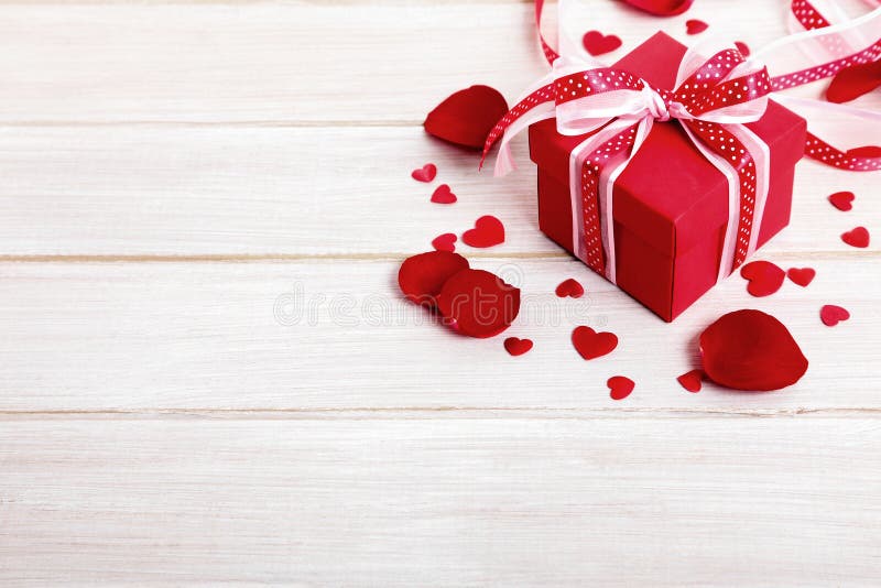 Valentine gift with rose petals, wooden copy space stock photo Valentine gift with rose petals, wooden copy space stock photo