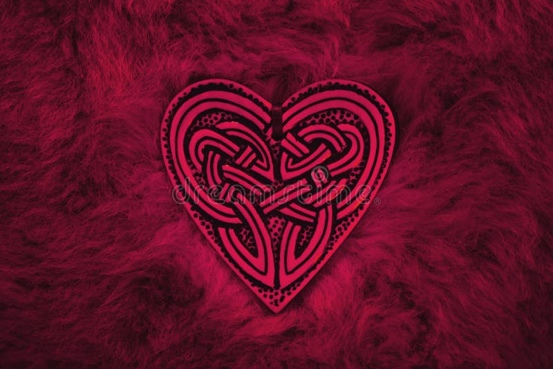 Valentine heart, symbol for love and friendship. Celtic heart lies on a fur rug