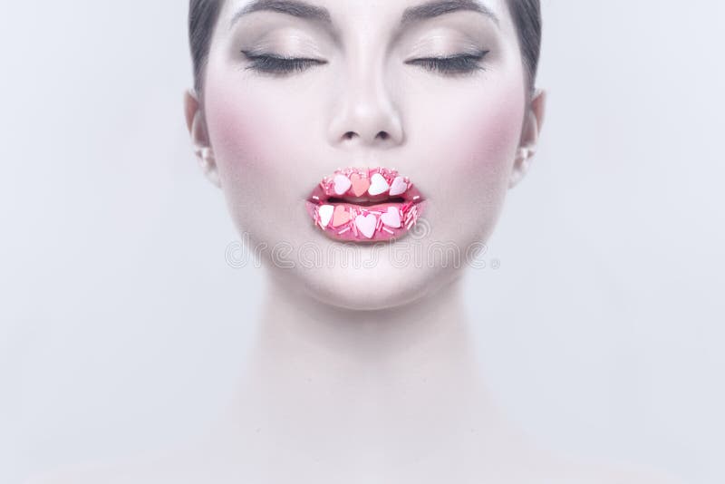 Valentine Hearts sweet makeup. Valentine`s Day make-up lips with pink hearts sugar sprinkles. Kiss on the Lips. Makeup