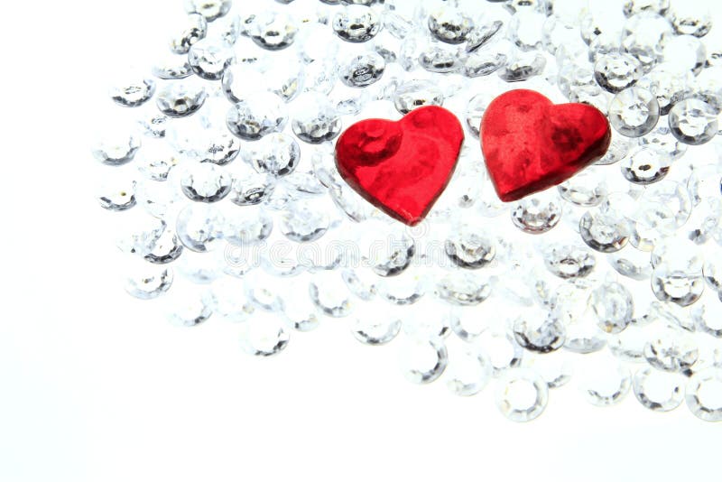 Two red hearts on glitter stones - symbol for Valentine's Day