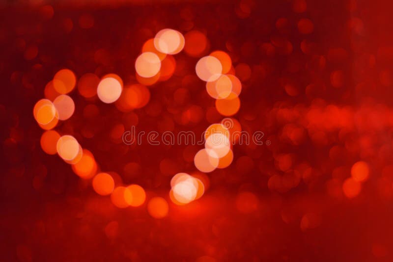 Valentine`s Day background, bokeh red heart. Red glitter sparkle confetti. Invitation to the Happy birthday.