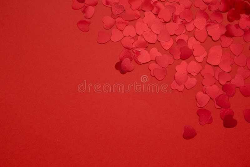 Red hearts confetti on red background. Valentines day