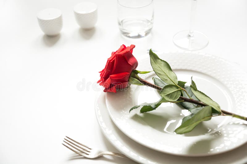 Valentine`s day or birthday romantic dinner. Romantic table setting with red rose royalty free stock photo Valentine`s day or birthday romantic dinner. Romantic table setting with red rose royalty free stock photo
