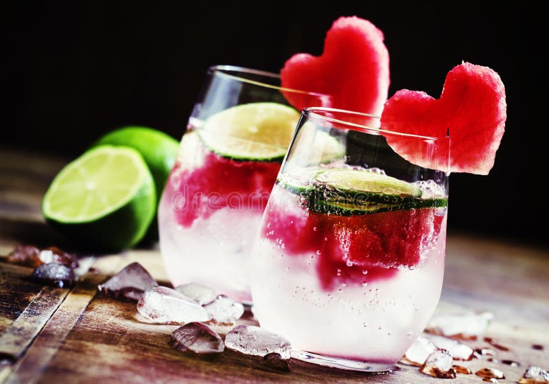 Valentine`s Day cocktail with red fruit hearts, selective focus