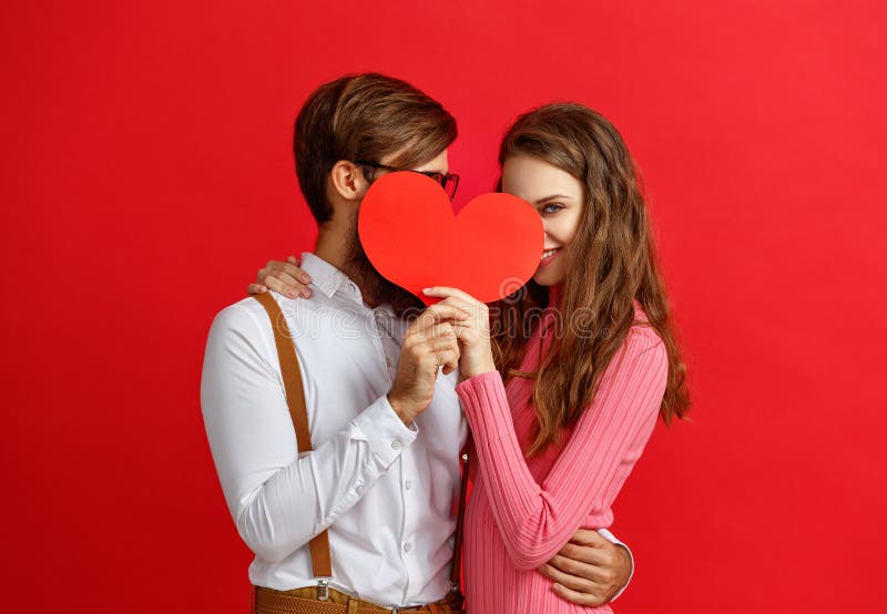 Valentine`s day concept. happy young couple with heart, flowers