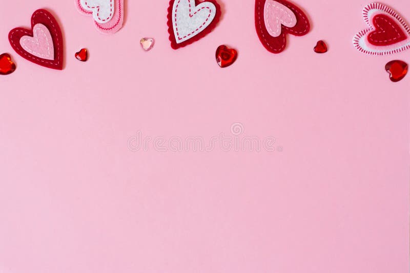 Valentine`s day greeting card concept. Border of hearts on a pink background