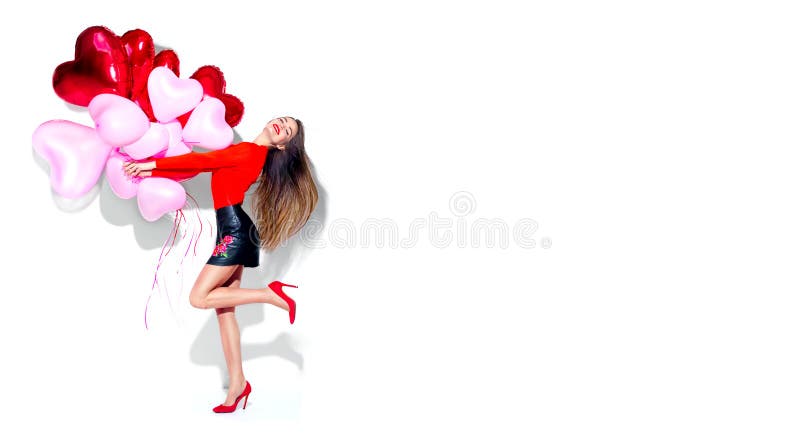 Valentine`s Day. Joyful beauty girl with colorful air balloons having fun, isolated on white background. Full length portrait