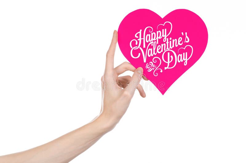 Valentine's Day and love theme: hand holds a greeting card in the form of a pink heart with the words Happy Valentine's day isolated on white background, studio