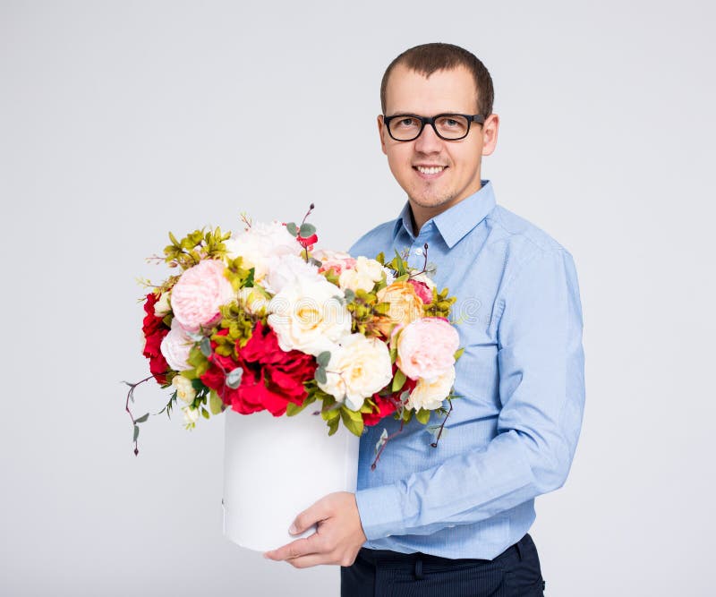 valentine`s day concept - portrait of young handsome man with flowers box stock photos valentine`s day concept - portrait of young handsome man with flowers box stock photos