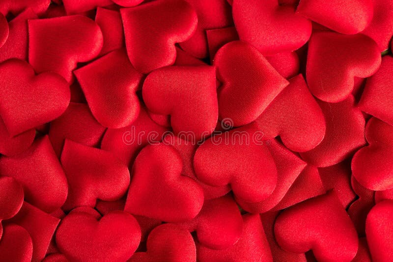 Valentine`s Day. Red heart shape backdrop. Abstract holiday Valentine background with red satin hearts. Love