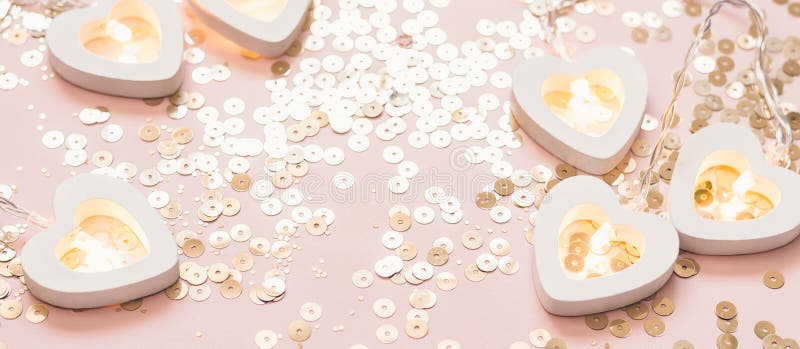 Valentine`s day or wedding party decoration. Festive pink background with heart garland and golden sparkles, banner
