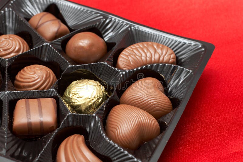 Valentines chocolates in box on red silk