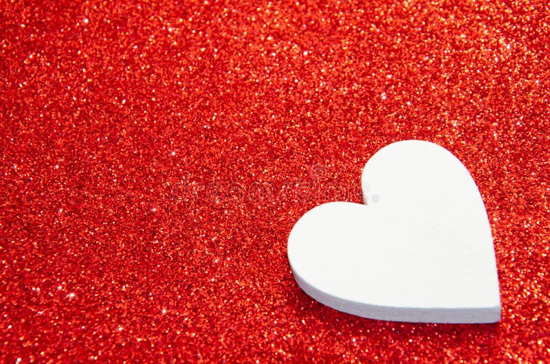 Valentines day abstract background. Shiny sparkle metallic glitter texture. White decorative Heart on red shiny background with