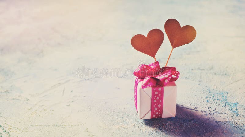 Valentines day background. Box of gift with two hearts over blu