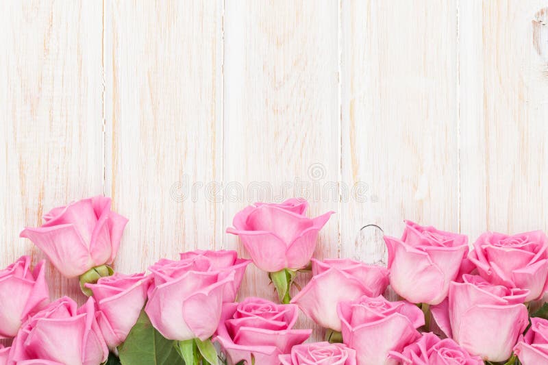 Valentines day background with pink roses over wooden table stock photo Valentines day background with pink roses over wooden table stock photo