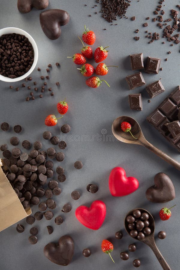 Valentines Day background with red and dark chocolates, hearts a