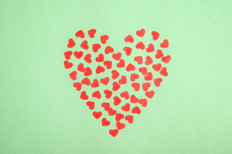 Valentines Day background. Red hearts on green background.