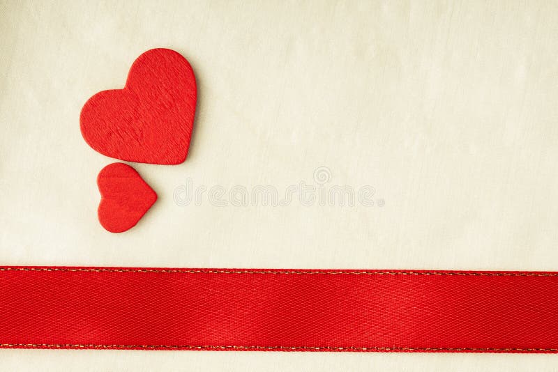 Valentines day background. Red satin ribbon and hearts.