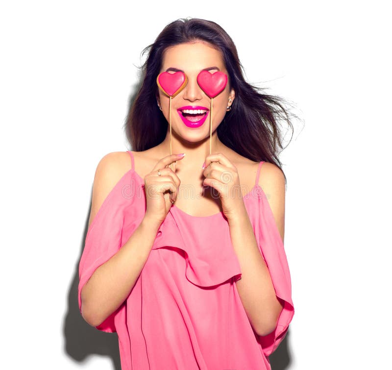 Valentines Day. Beauty girl with Valentine Heart shaped cookies in her hands royalty free stock photos Valentines Day. Beauty girl with Valentine Heart shaped cookies in her hands royalty free stock photos