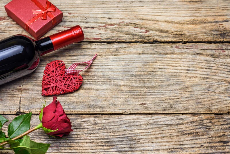 Red rose, a bottle of wine, heart and gift box. Valentines day royalty free stock images Red rose, a bottle of wine, heart and gift box. Valentines day royalty free stock images