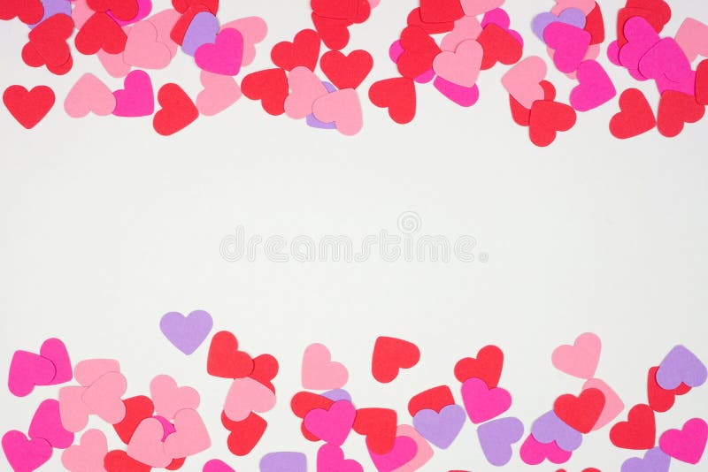 Valentines Day double border with paper heart confetti. Top down view over a white background. Copy space. Valentines Day double border with paper heart confetti. Top down view over a white background. Copy space