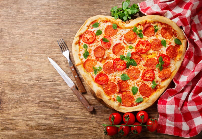 Valentines Day Food. Heart Shapped Pepperoni Pizza with Green Basil ...