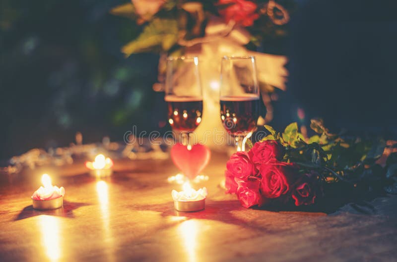 Valentines dinner romantic love concept Romantic table setting decorated with Red heart and couple champagne glass roses flower