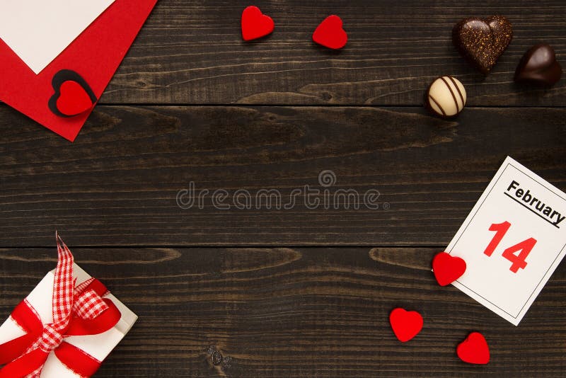 Valentinsgruß ` s Tageshintergrund mit Kopienraum Valentinsgruß ` s Tageskarte, -Geschenkbox und -schokolade auf dem Holztisch lizenzfreies stockbild Valentinsgruß ` s Tageshintergrund mit Kopienraum Valentinsgruß ` s Tageskarte, -Geschenkbox und -schokolade auf dem Holztisch lizenzfreies stockbild