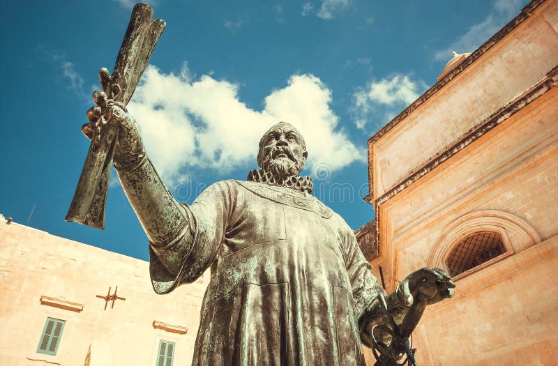 Clouds over bronze monument to the capital founder, Master Jean de Valette holding the city plan and sword