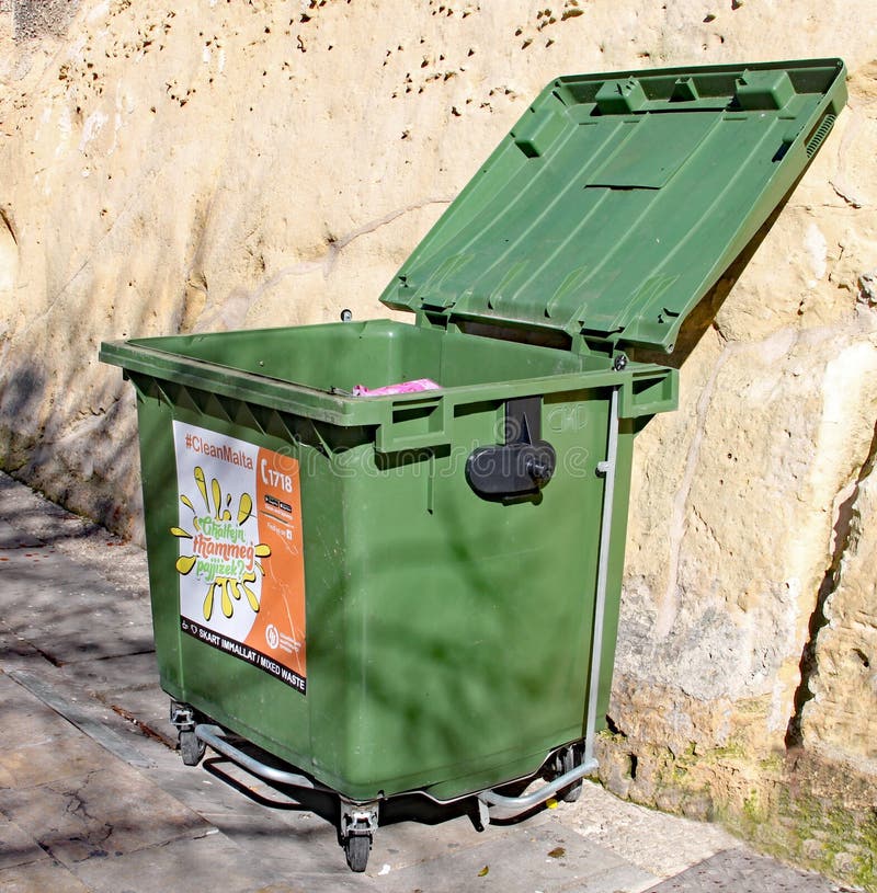 Large green commercial garbage bin with one side lid eft open Stock Photo -  Alamy