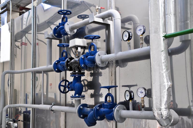 Valves in a factory where the pressure system is controlled royalty free stock photos