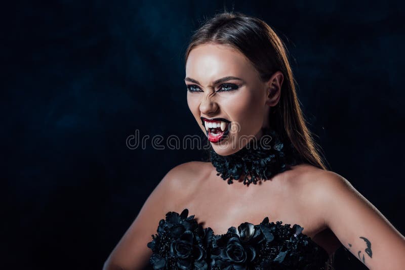 Vampire Girl with Fangs in Black Gothic Dress Isolated on Black Stock ...